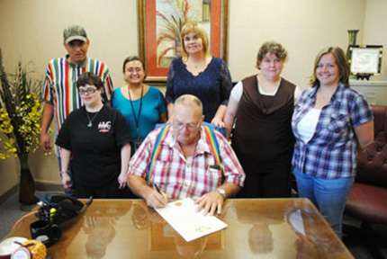 Pictured in the back row from left to right are Carl Anthony Bloodgood, Program Coordinator Brandy Welch, Executive Director Ann Graff, Stacy Fisher and Vocational Trainer Rachel Fizer. The front row includes Gina Chevalier and Mayor Pro Tem Ronald Duvall.