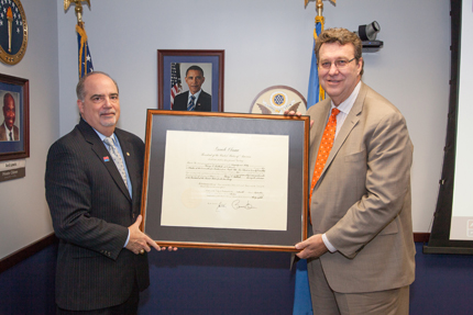 Chairperson J. Anthony Poleo (left) swears in Harry P. Hallock (right), as new Commission member representing the Department of the Army