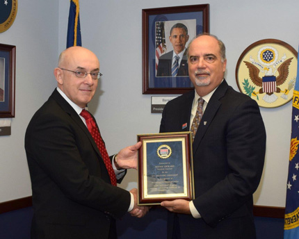 Poleo (right) presented Outstanding Contributions Award to recipient Dennis Lockard (left).