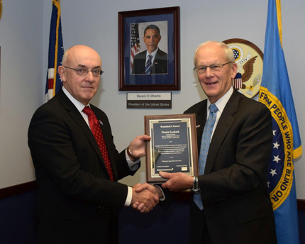 SourceAmerica CEO Chamberlin (right) presented a plaque to Lockard (left), for his service to the AbilityOne Program. 