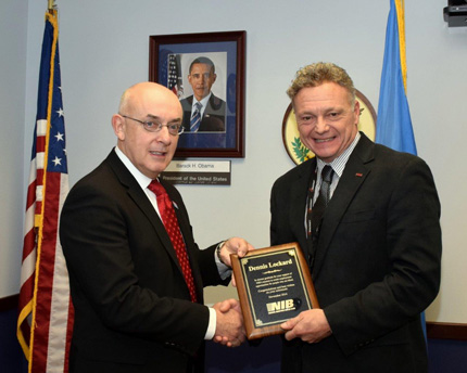 Lynch (right) presented a plaque to Lockard (left), for his service to the AbilityOne Program. 