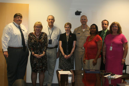 Members of NAVAIR's contracts team and the Aircrew Systems Program Office recently received "Commitment in Action" certificates for their work supporting an AbilityOne® Program. From left, Jim Meade, Janice Woehrer, Dan Ratcliff, Kimberly Zeich, Capt. John T. Palmer, Sheila Milburn, Greg Szczyglowski and Tara Capecci.