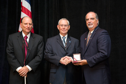 Chairperson J. Anthony Poleo (right) and Vice Chairperson  James A. Kesteloot (left) with recipient Billy Sparkman (center).