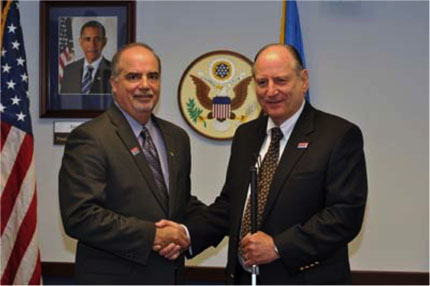 Chairperson Poleo, left, shakes hands with Vice Chairperson Kesteloot