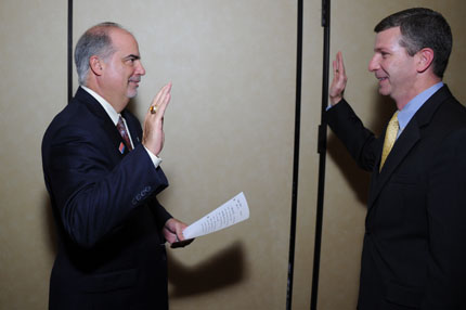 Chairperson Tony Poleo administers the oath of office to William Sisk, GSA