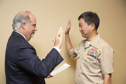 Chairperson J. Anthony Poleo swears in Commission member RADM Jonathan A. Yuen, Department of the Navy.