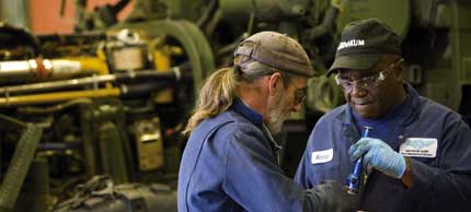 Photo of men working in shop.