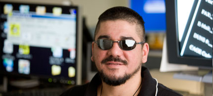 Photo of man in front of computers.