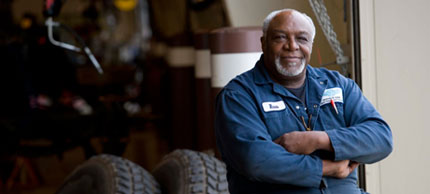 Photo of man next to tires.