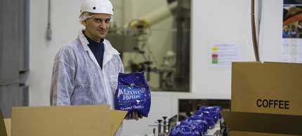 Photo of man packaging coffee.