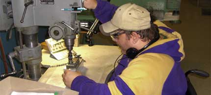 Photo of man using drillpress.