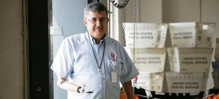 Photo of man sorting mail.